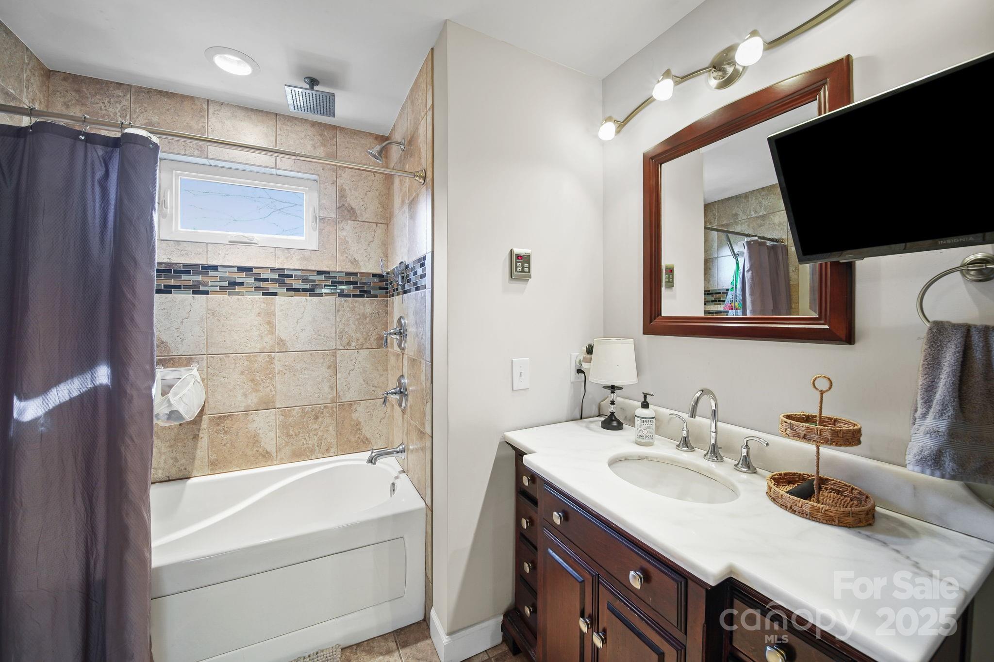 9116 Brief Road Mint Hill, NC 28227 - Photo 11 of 24 a bathroom with a granite countertop sink mirror and bathtub