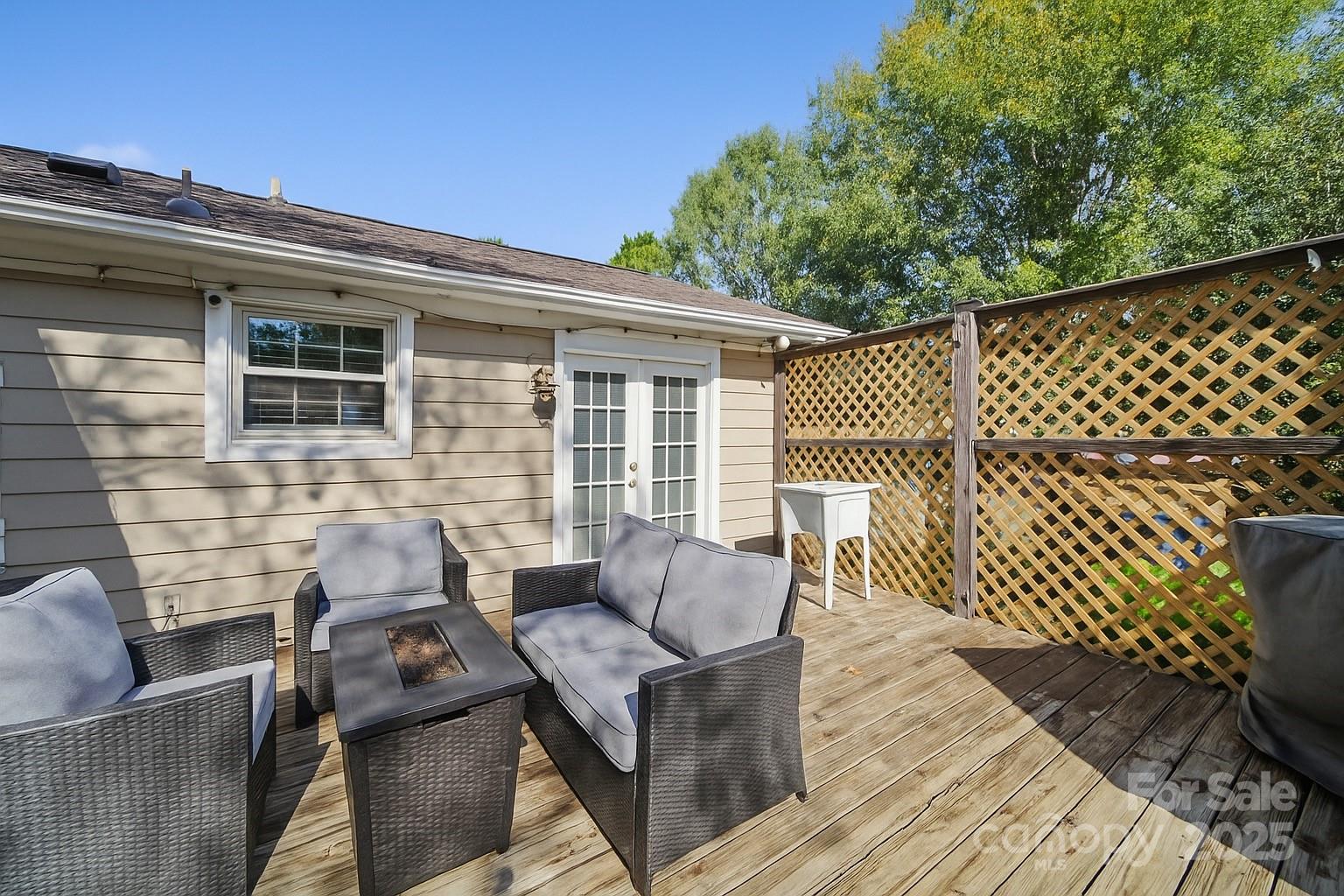 9116 Brief Road Mint Hill, NC 28227 - Photo 16 of 24 a view of a deck with couches floor to ceiling window with wooden fence