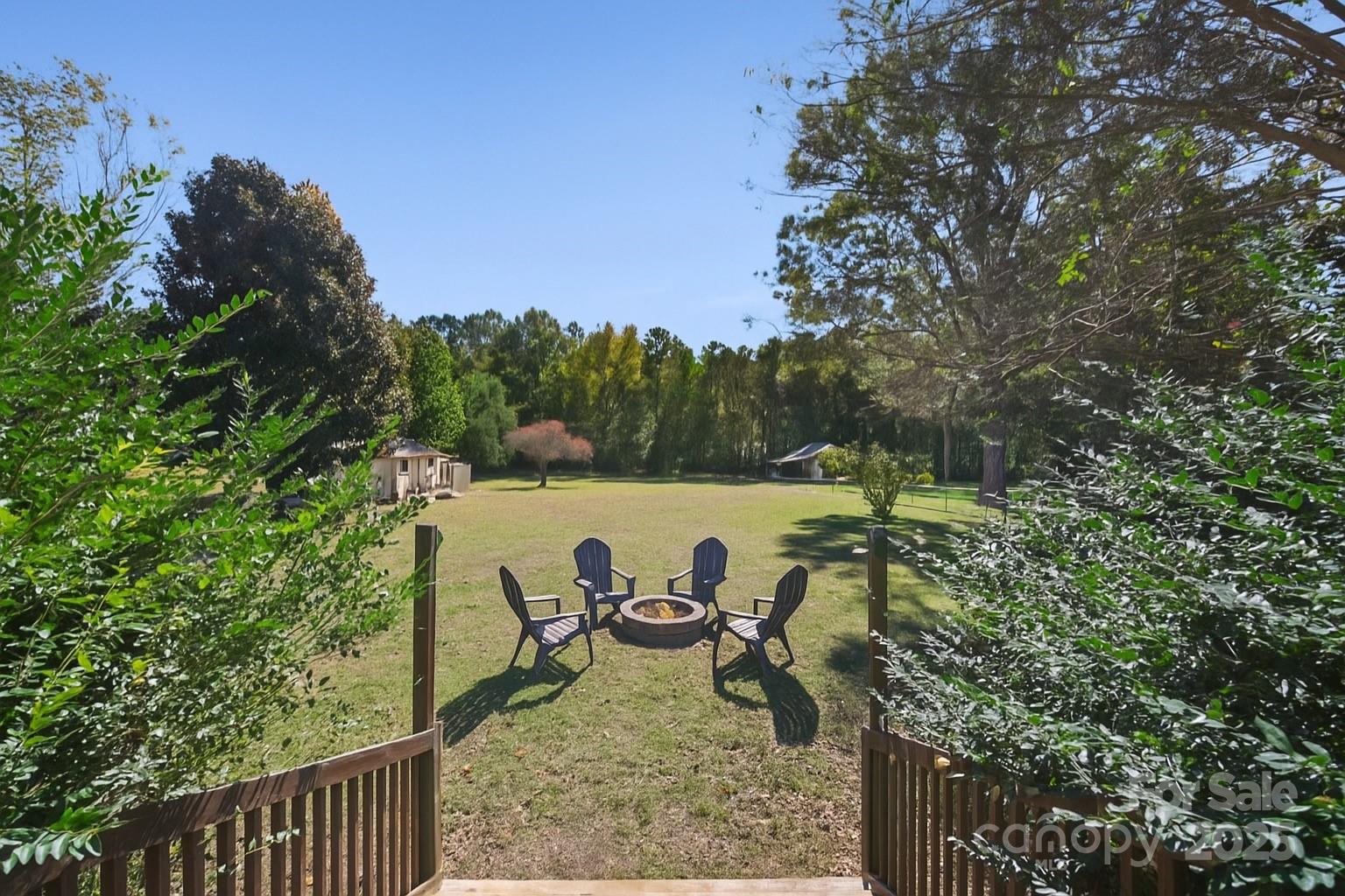 9116 Brief Road Mint Hill, NC 28227 - Photo 17 of 24 a view of a backyard of a house with table and chairs