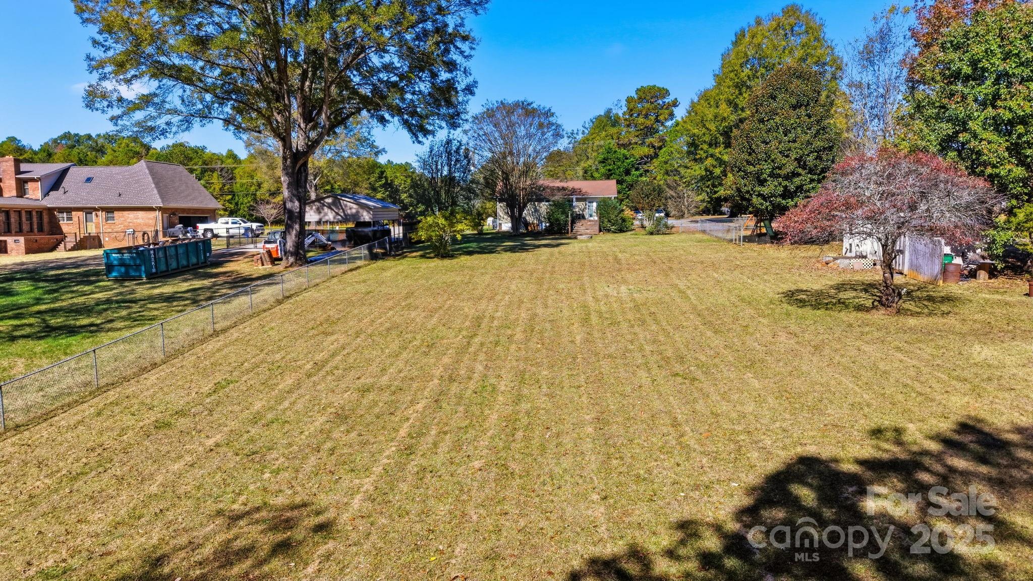 9116 Brief Road Mint Hill, NC 28227 - Photo 20 of 24 a view of swimming pool with outdoor seating and covered with trees