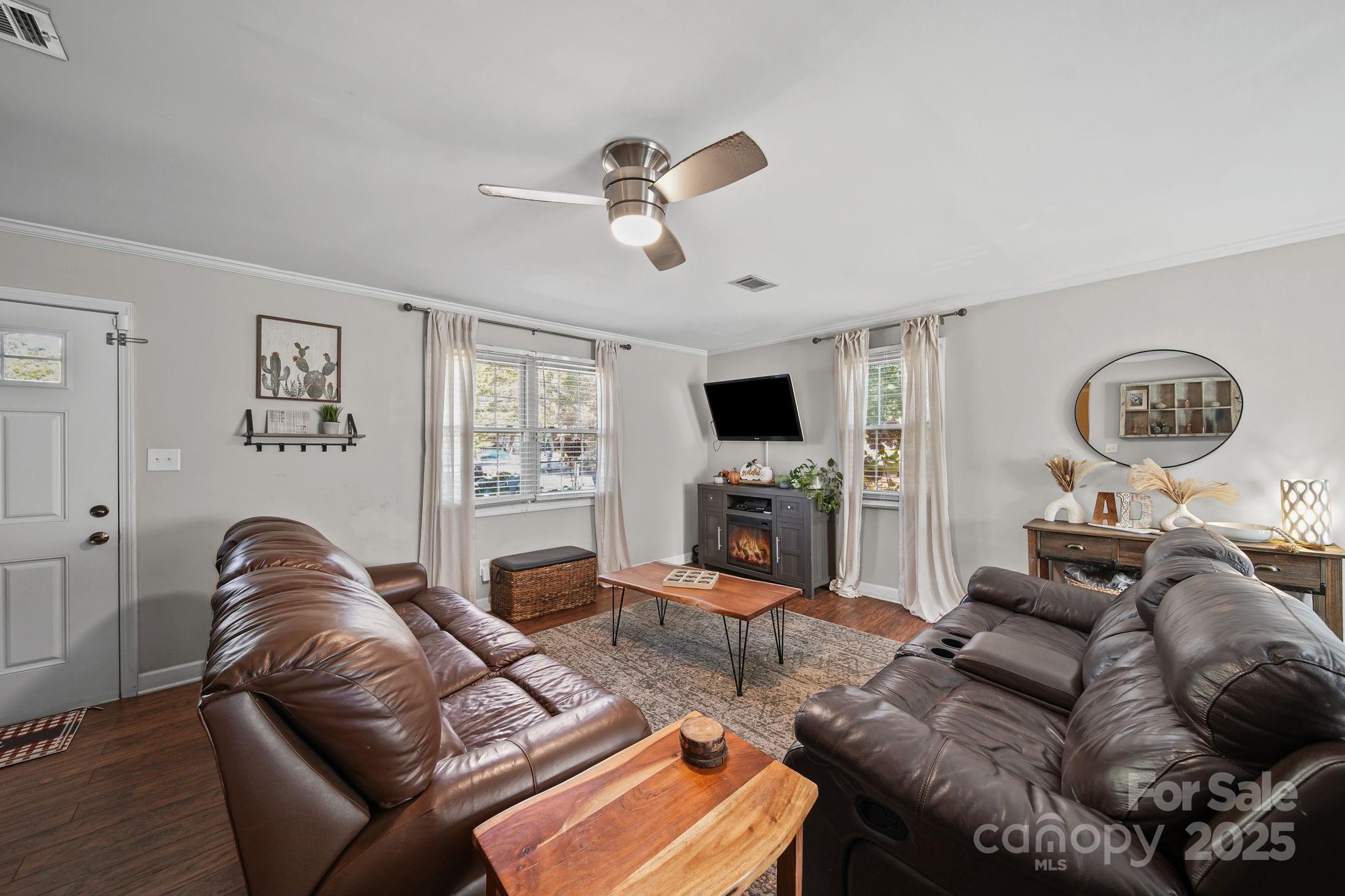 9116 Brief Road Mint Hill, NC 28227 - Photo 5 of 24 a living room with furniture a large window and a fireplace