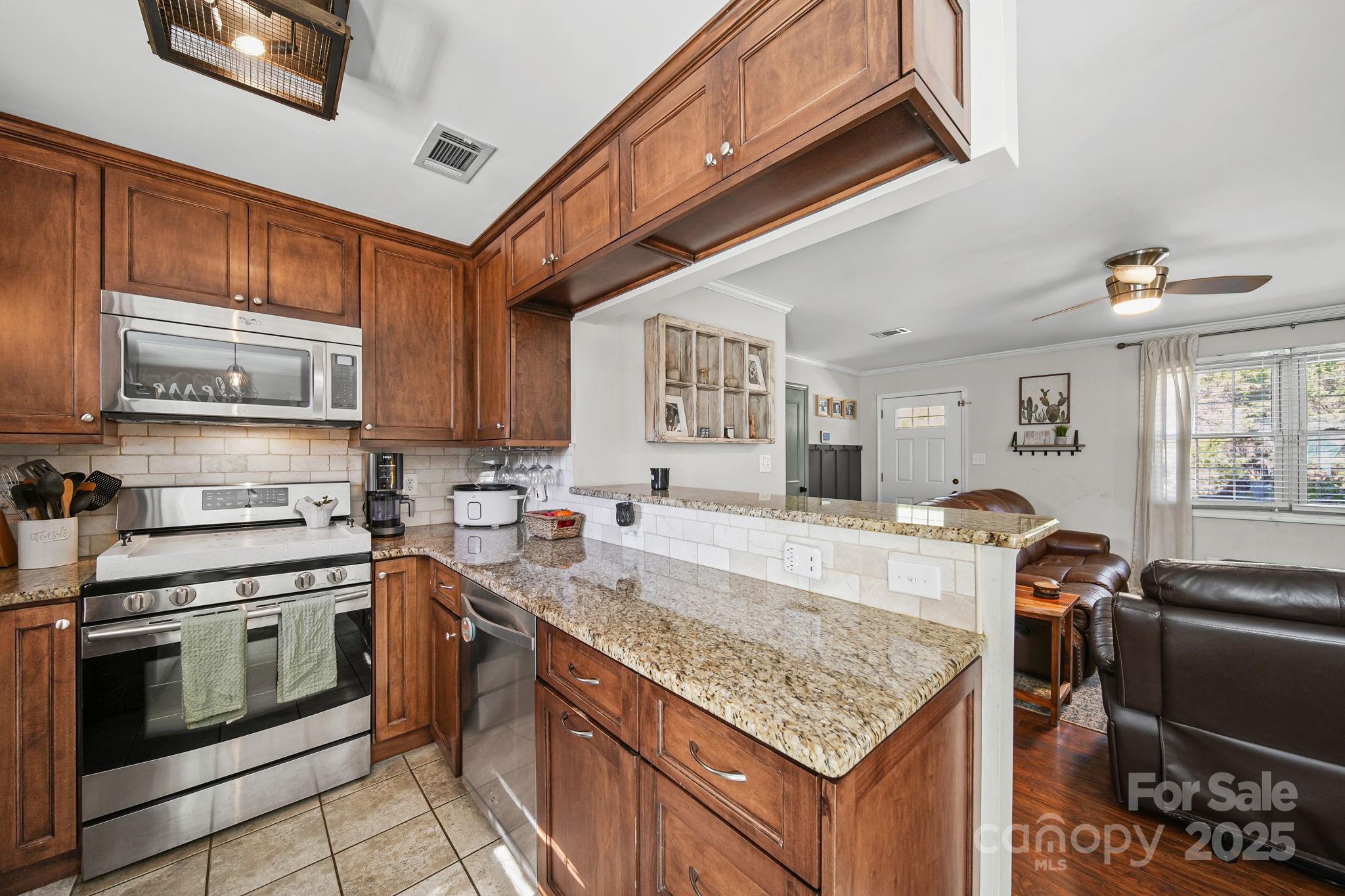 9116 Brief Road Mint Hill, NC 28227 - Photo 6 of 24 a kitchen with stainless steel appliances granite countertop a stove top oven a sink dishwasher and cabinets