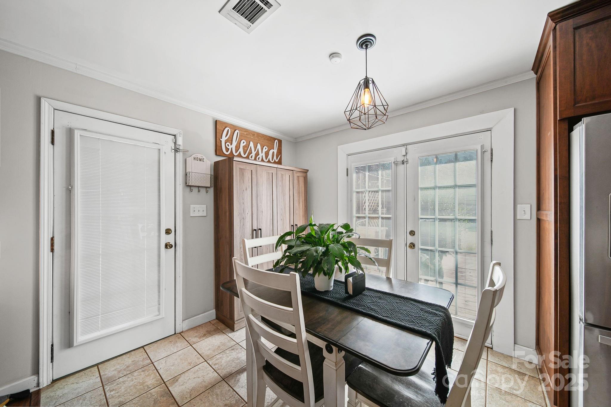 9116 Brief Road Mint Hill, NC 28227 - Photo 8 of 24 a dining room with furniture potted plants and wooden floor