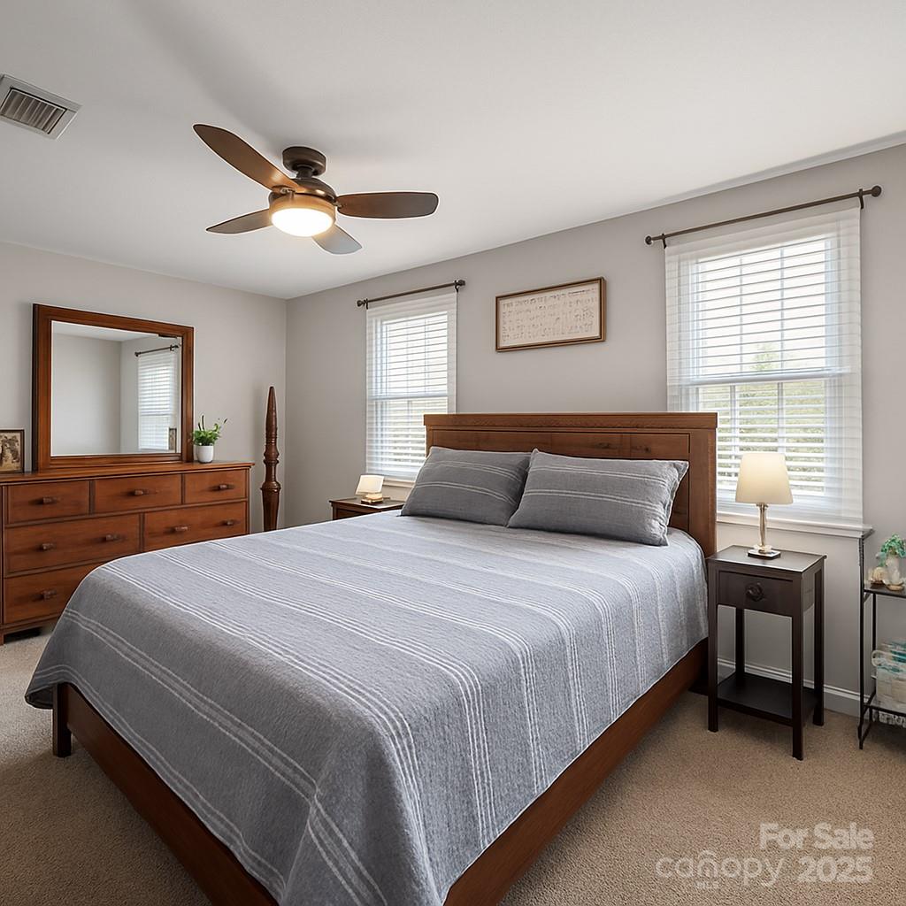 9116 Brief Road Mint Hill, NC 28227 - Photo 10 of 24 a bedroom with a bed and a chandelier