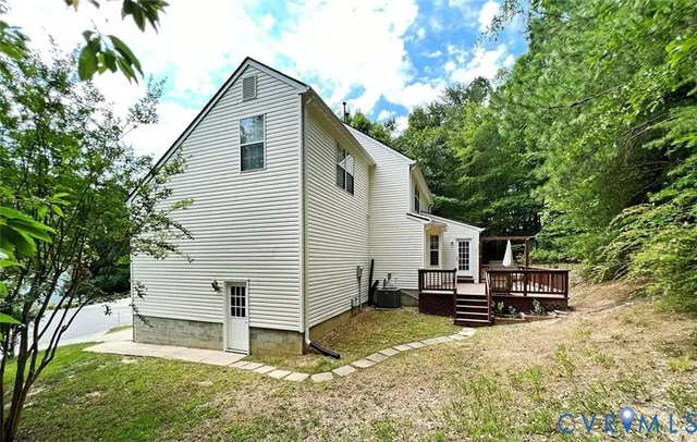 a view of a backyard with large trees and plants