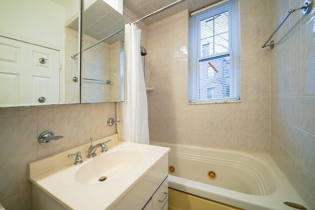 311 Tappan Street, Unit 3 Brookline, MA 02445 - Photo 31 of 35 a bathroom with a sink and a bathtub