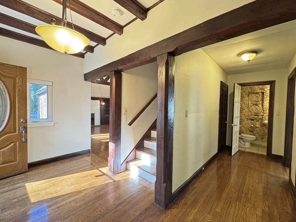 280 Quinobequin Road Newton, MA 02468 - Photo 12 of 31 a view of an entryway with wooden floor and door