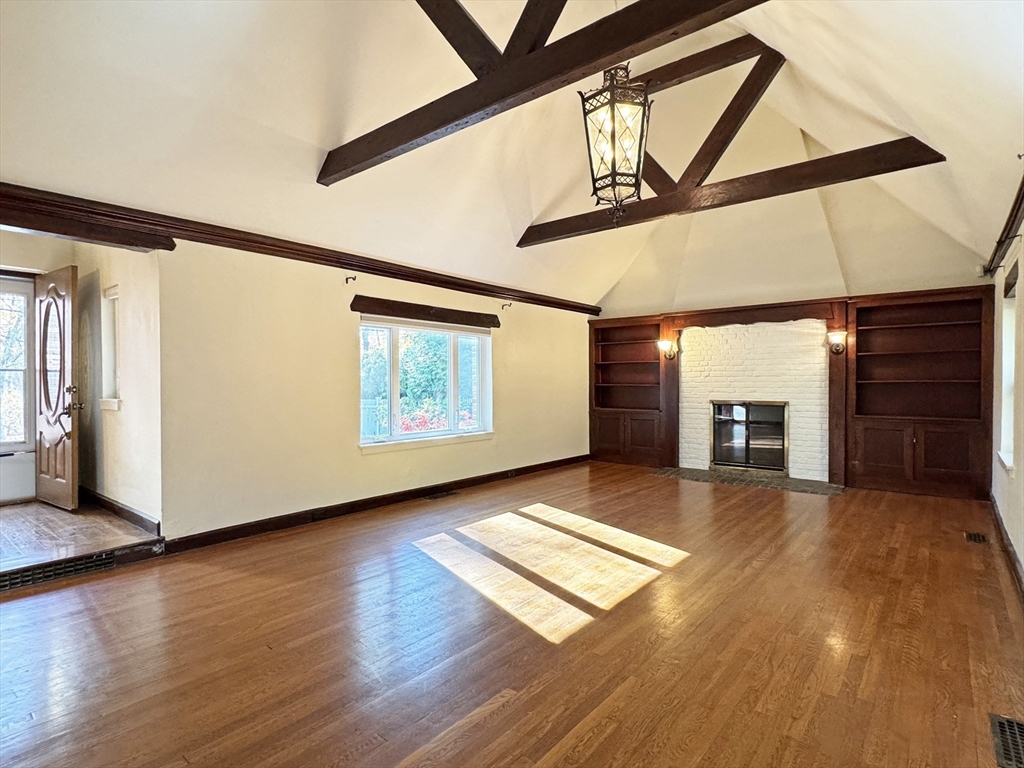 280 Quinobequin Road Newton, MA 02468 - Photo 13 of 31 a view of an empty room with wooden floor and a window