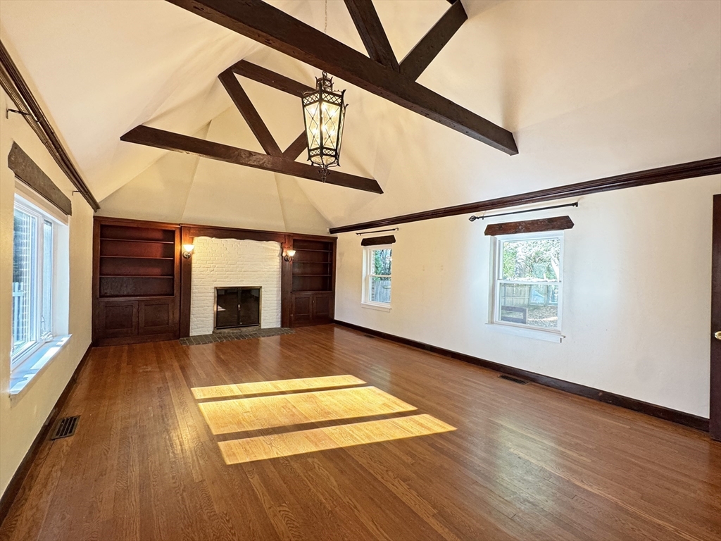 280 Quinobequin Road Newton, MA 02468 - Photo 15 of 31 a view of an empty room with wooden floor and a window