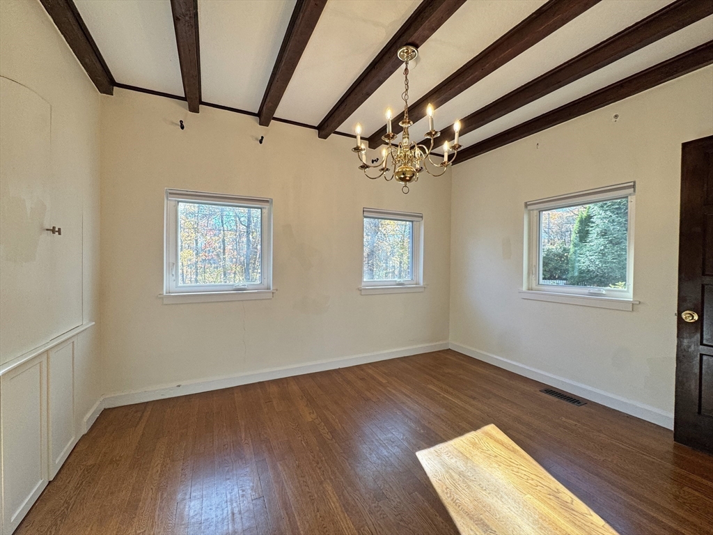 280 Quinobequin Road Newton, MA 02468 - Photo 16 of 31 a view of an empty room with wooden floor and a window