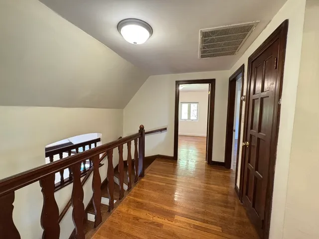 a view of gallery with wooden floor