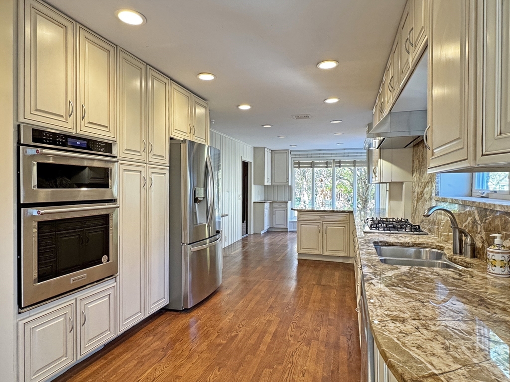 280 Quinobequin Road Newton, MA 02468 - Photo 2 of 31 a kitchen with stainless steel appliances a refrigerator a stove top oven and kitchen island