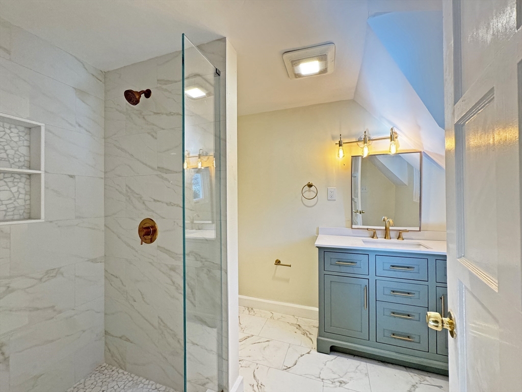 280 Quinobequin Road Newton, MA 02468 - Photo 23 of 31 a bathroom with a granite countertop sink mirror and shower
