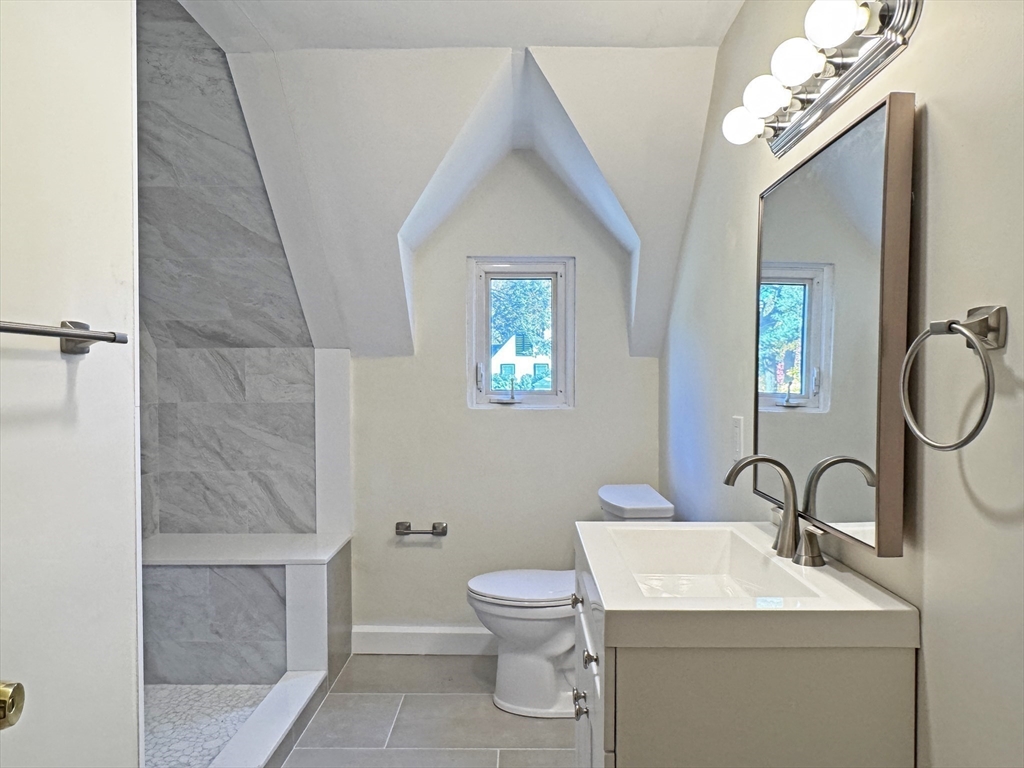 280 Quinobequin Road Newton, MA 02468 - Photo 25 of 31 a bathroom with a toilet a sink and mirror