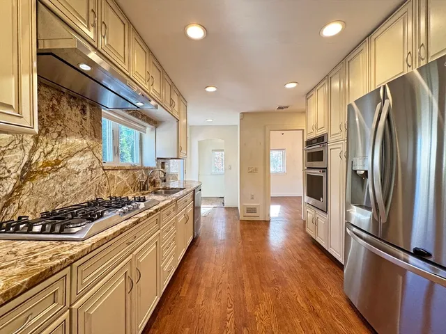 a kitchen with stainless steel appliances a refrigerator and a stove