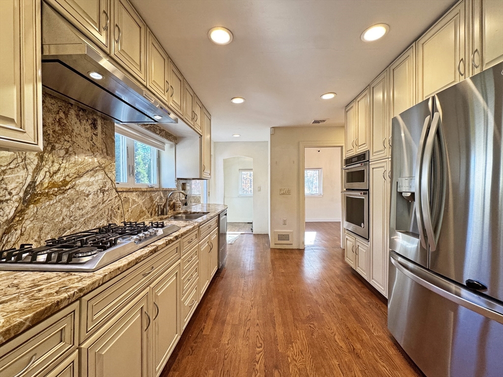 280 Quinobequin Road Newton, MA 02468 - Photo 3 of 31 a kitchen with stainless steel appliances a refrigerator and a stove