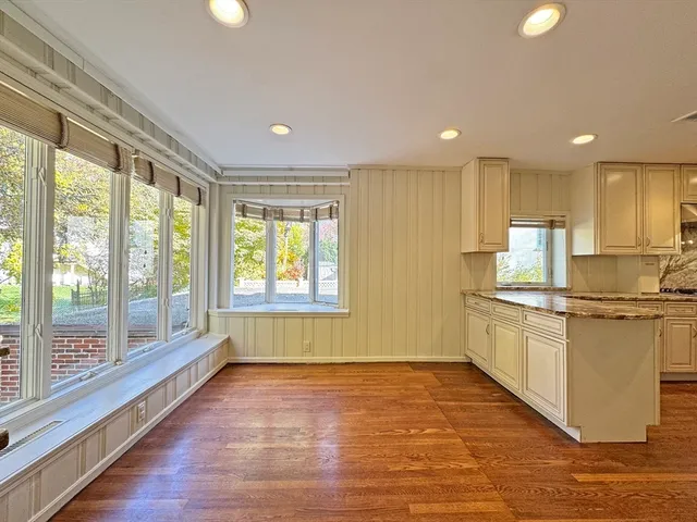 a kitchen with a sink wooden floor and window