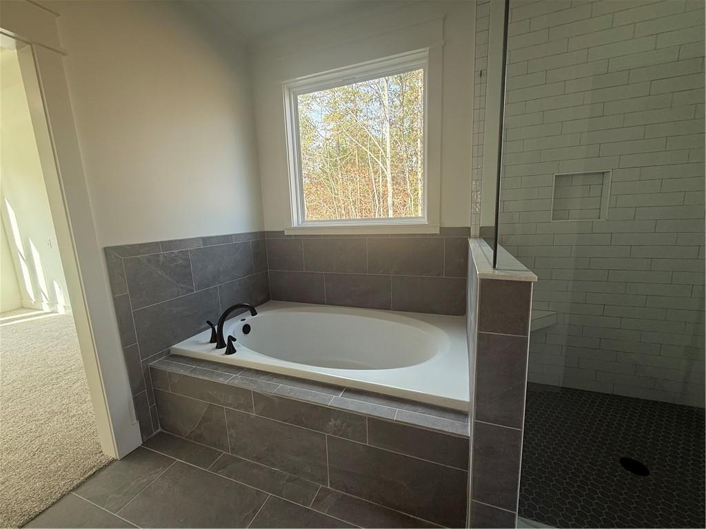 1723 Darby Road Waleska, GA 30183 - Photo 15 of 29 a bath tub sitting in a bathroom next to a window