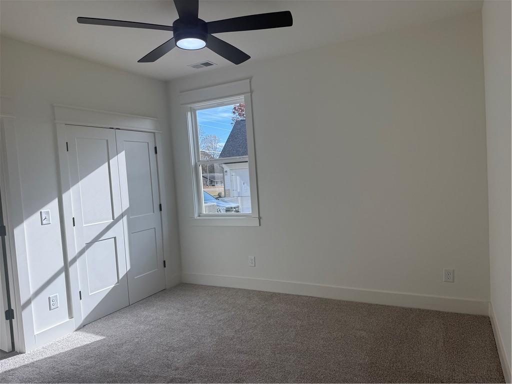 1723 Darby Road Waleska, GA 30183 - Photo 18 of 29 an empty room with windows and fan