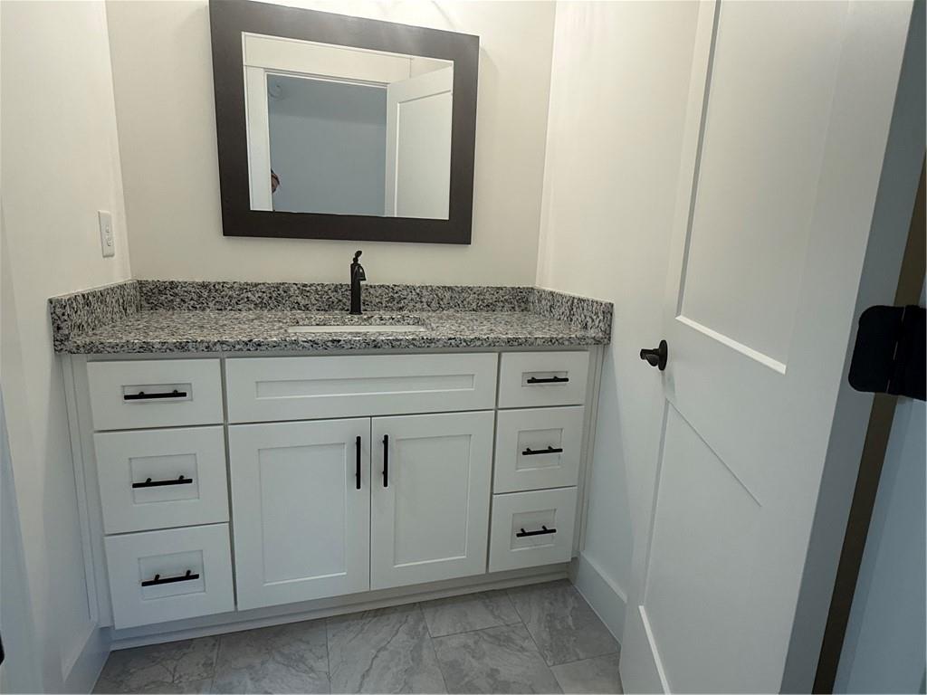 1723 Darby Road Waleska, GA 30183 - Photo 27 of 29 a bathroom with a granite countertop sink and a mirror