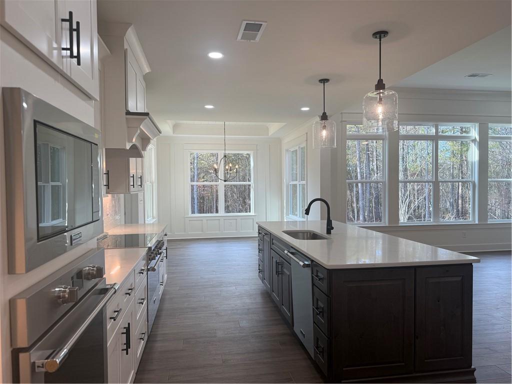 1723 Darby Road Waleska, GA 30183 - Photo 10 of 29 a kitchen with granite countertop a sink stove and cabinets