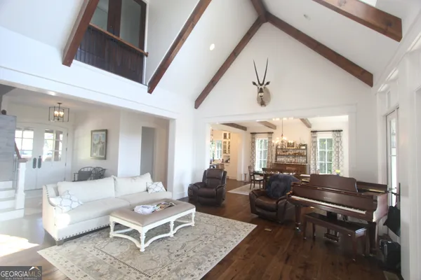 a living room with furniture a table and a large window
