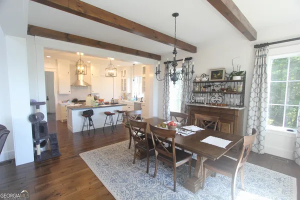 a dining room with furniture and wooden floor