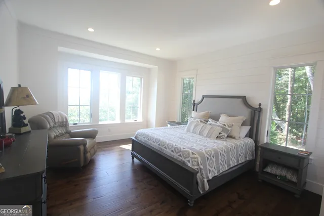 a bedroom with bed couch and window