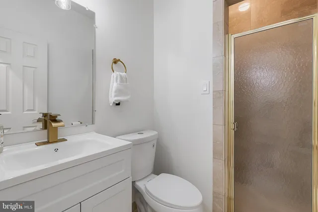 a bathroom with a sink a toilet and mirror