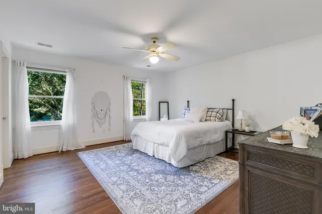 a spacious bedroom with a bed and a window