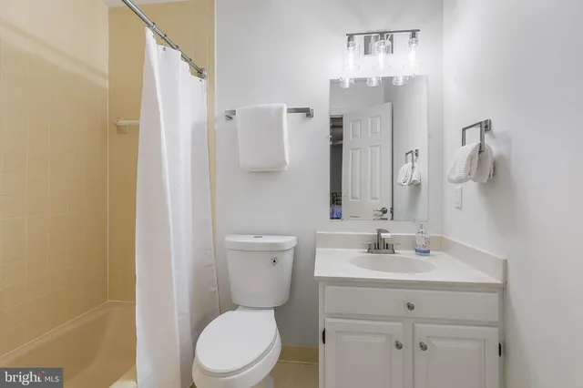 a bathroom with a toilet sink and shower