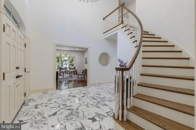a view of a livingroom with wooden floor and stairs