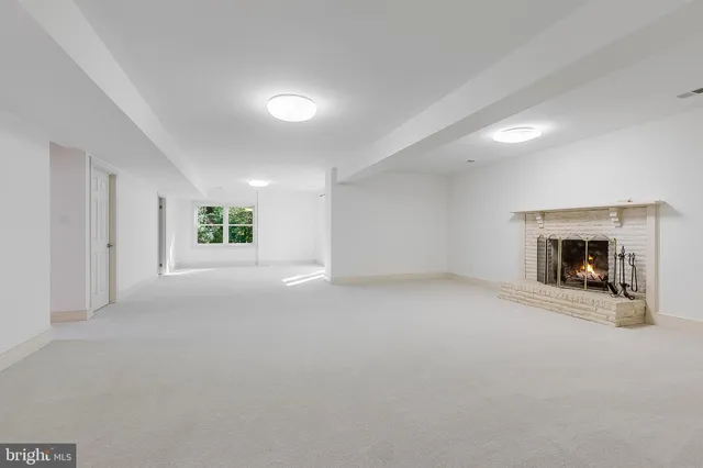 a view of an empty room with a fireplace