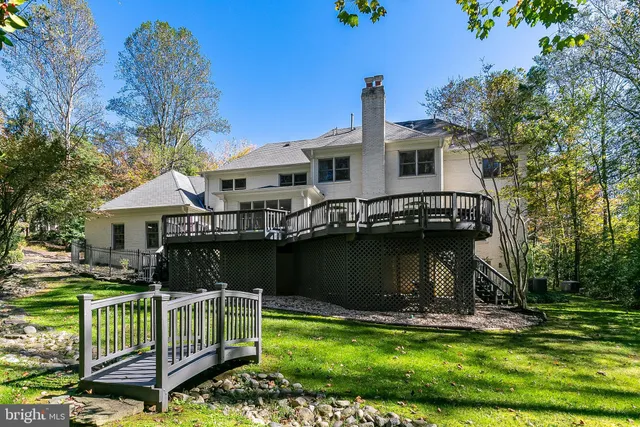 a front view of a house with a garden and yard