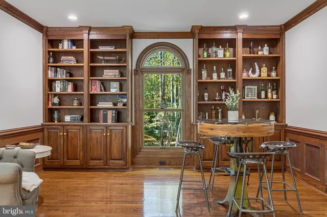 a view of a workspace with furniture and a bookshelf