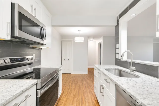 a view of a storage and utility room with wooden floor