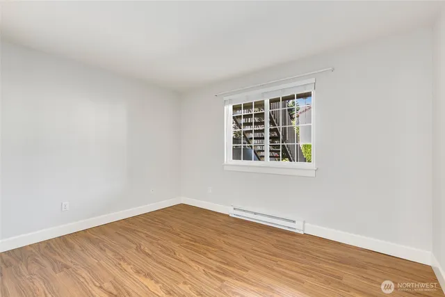 a view of a room with wooden floor