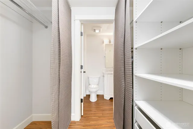 a bathroom with a granite countertop sink a toilet and shower