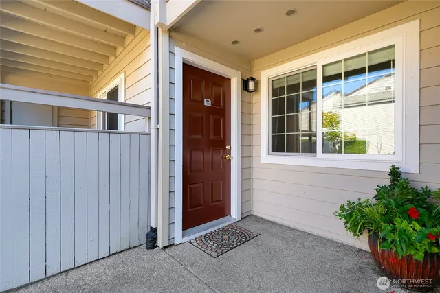 a view of a kitchen an empty room and wooden floor