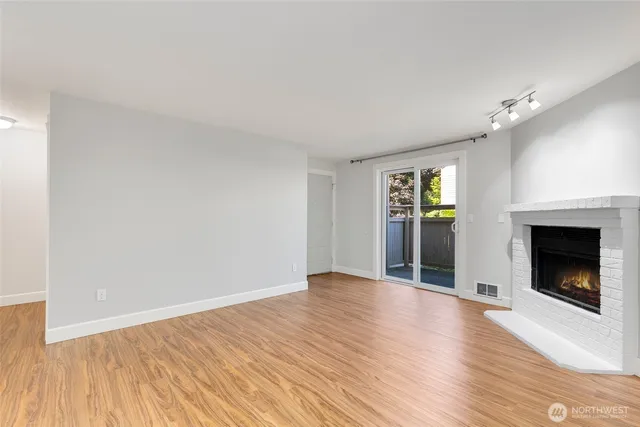 a kitchen with granite countertop a stove cabinets and wooden floor