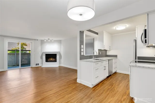 a spacious bathroom with a granite countertop sink and a mirror