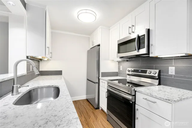a kitchen with a sink stove and microwave