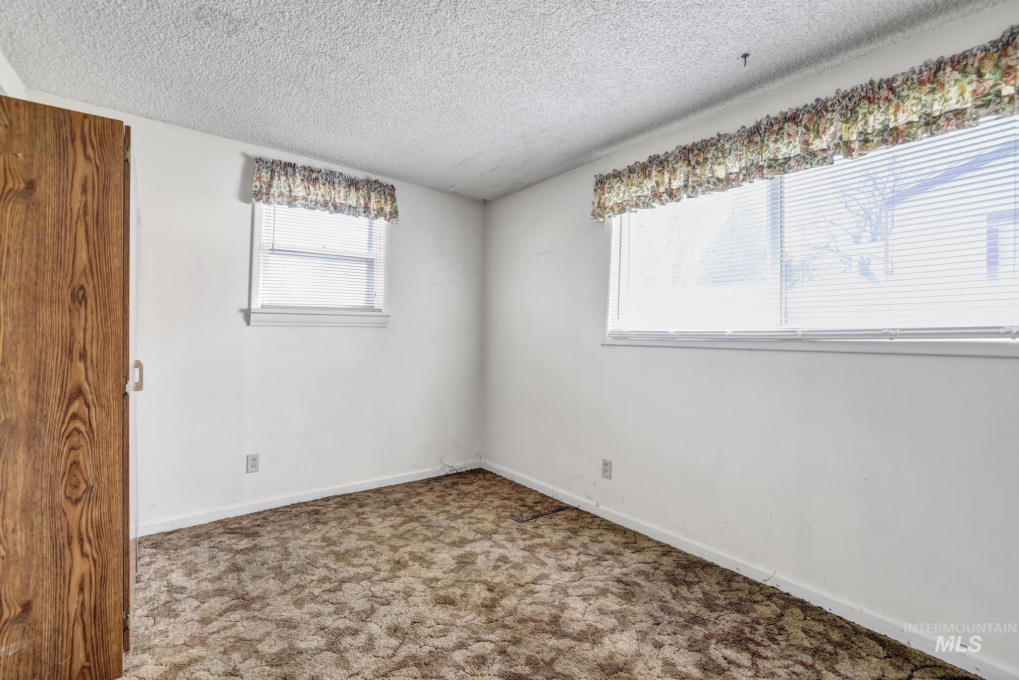 415 Adams Street Twin Falls, ID 83301 - Photo 12 of 20 Unfurnished room with carpet and a textured ceiling
