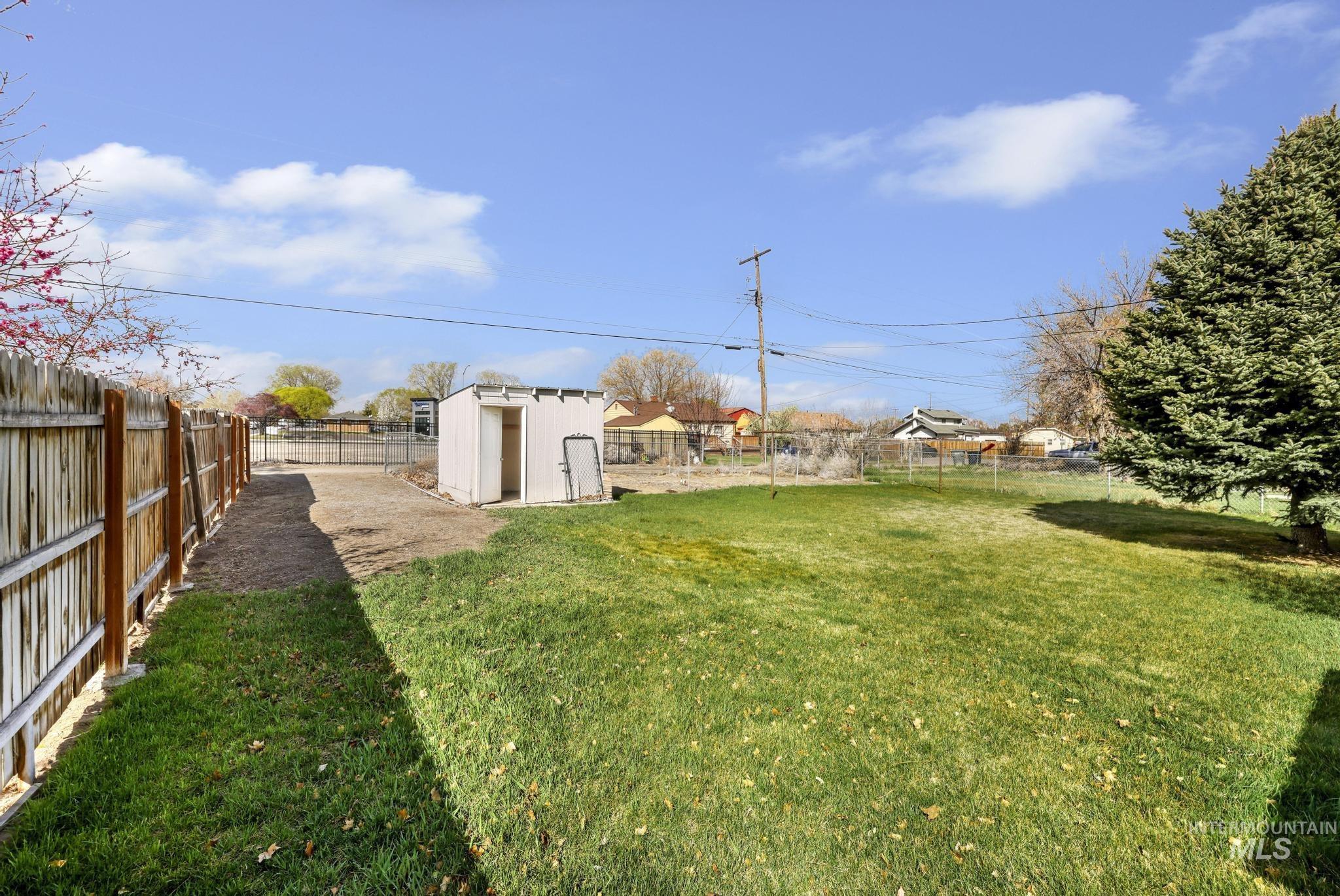 415 Adams Street Twin Falls, ID 83301 - Photo 18 of 20 Fenced backyard featuring a storage unit
