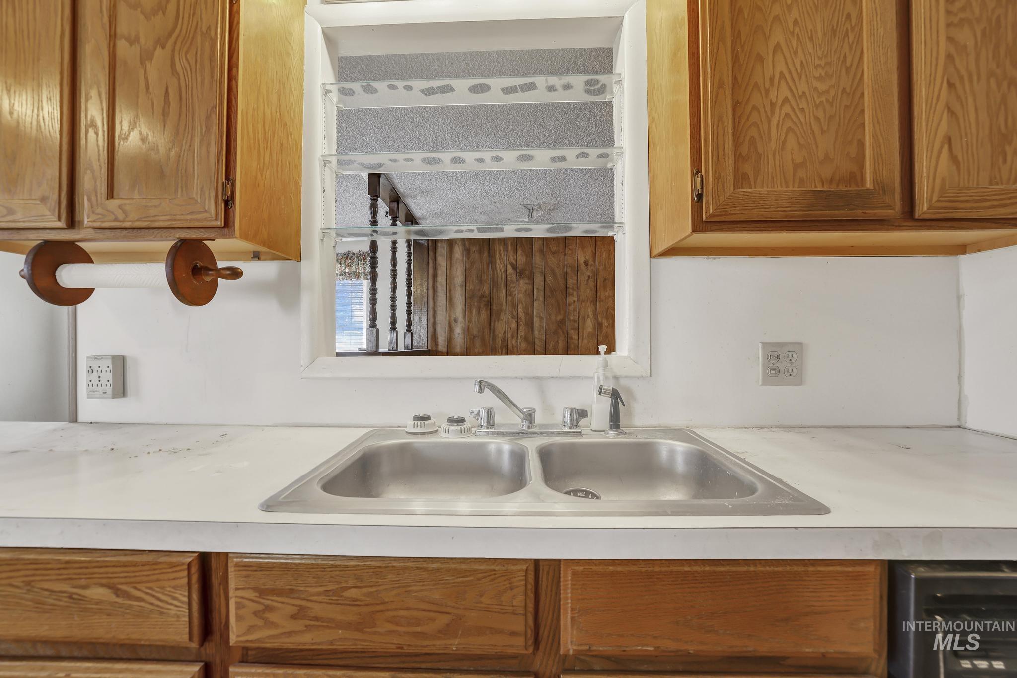 415 Adams Street Twin Falls, ID 83301 - Photo 5 of 20 Kitchen with wood finish cabinets and light countertops