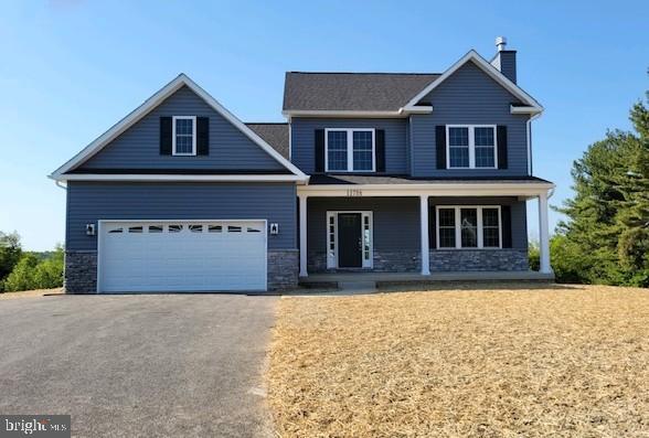 12706 Handboard Road Union Bridge, MD 21791 - Photo 1 of 1 a front view of a house with a yard and garage
