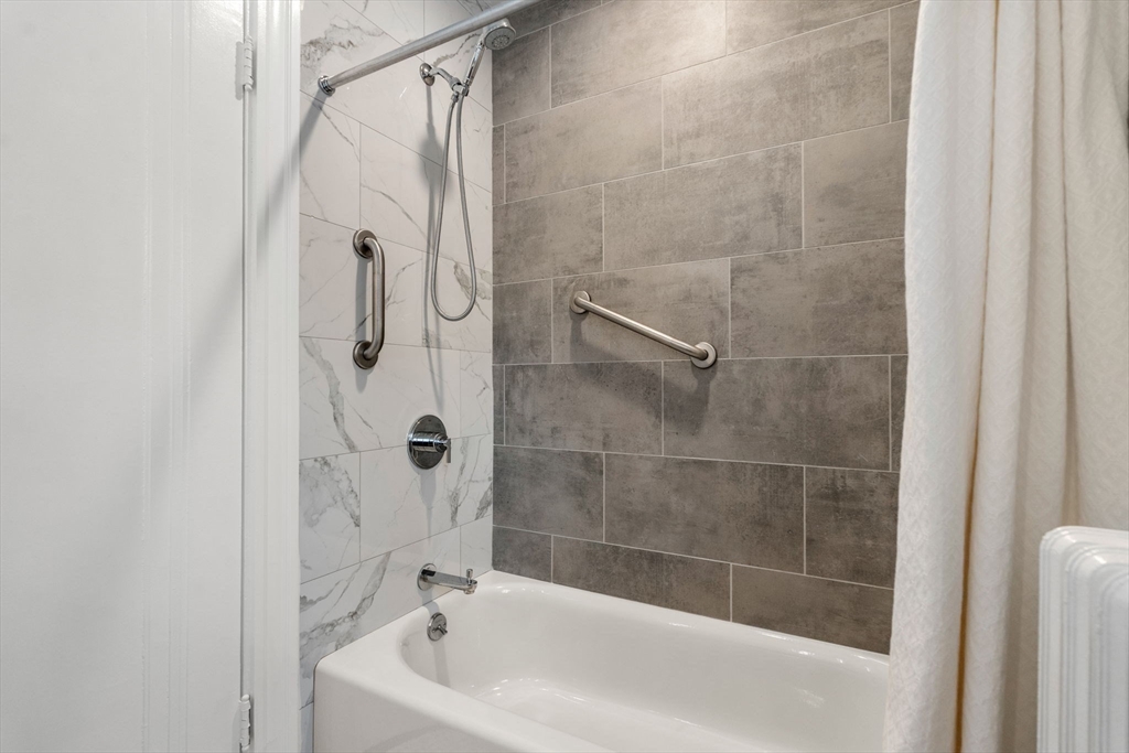 15 Gammons Road Newton, MA 02468 - Photo 14 of 20 a bathroom with a bathtub and a shower