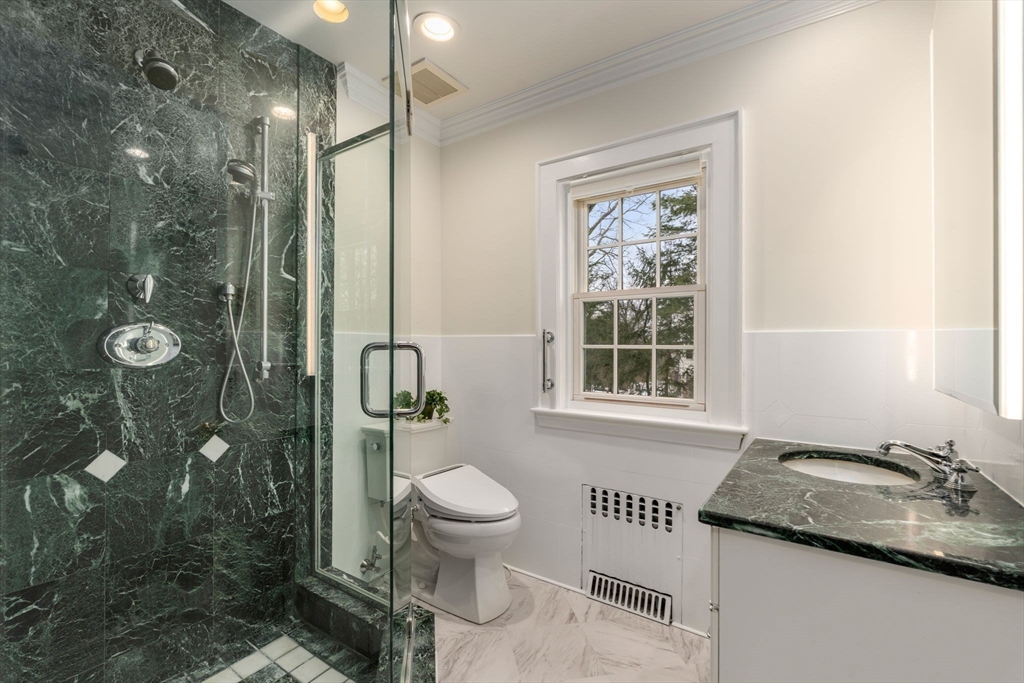 15 Gammons Road Newton, MA 02468 - Photo 18 of 20 a bathroom with a granite countertop sink toilet a mirror and shower