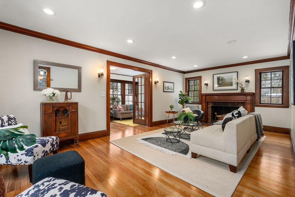 15 Gammons Road Newton, MA 02468 - Photo 3 of 20 a living room with furniture a fireplace and a flat screen tv