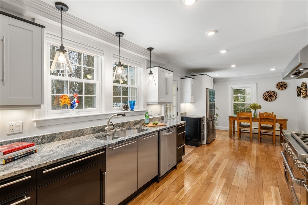 15 Gammons Road Newton, MA 02468 - Photo 10 of 20 a kitchen with stainless steel appliances granite countertop a sink stove and wooden floor